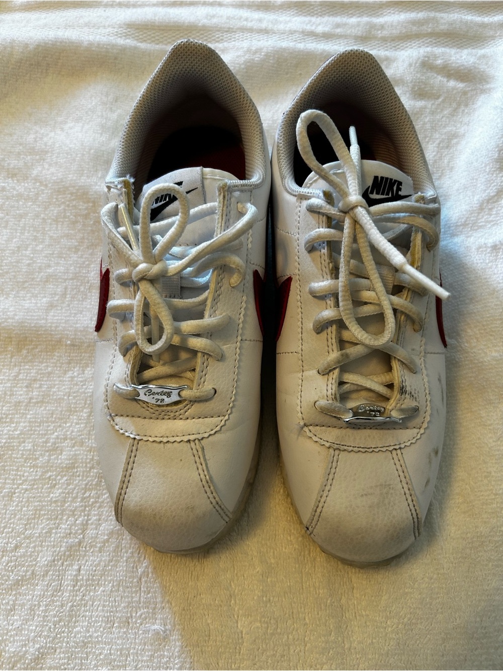 Nike Men’s White Sneakers with Red Swoosh Accent